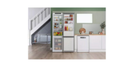 A fridge freezer positioned under a staircase in a modern home