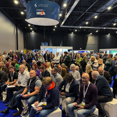 Audience watching a lighting session at the UK Housing Conference 2025.